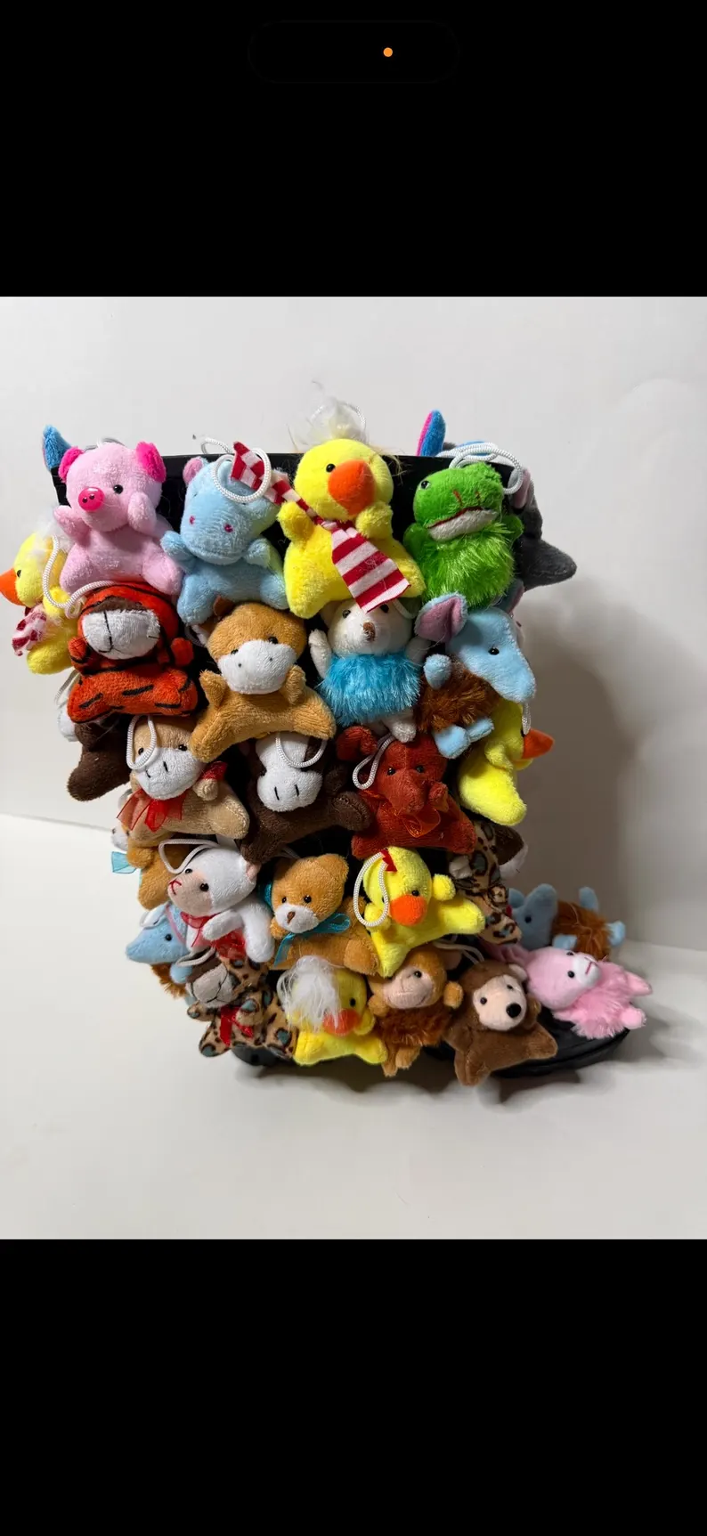 Black boots covered head to toe in small plush animals